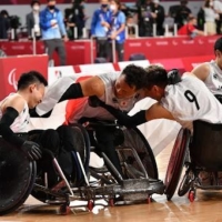 Japan\'s wheelchair rugby team celebrates after beating Australia in the bronze medal match on Sunday.  | DAN ORLOWITZ 
