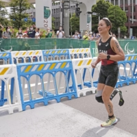 Mami Tani competes in the women\'s PTS5 triathlon on Sunday in Tokyo.  | KYODO 