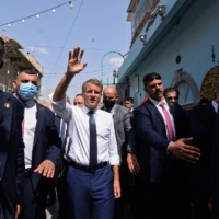 French President Emmanual Macron greets people in Mosul, Iraq, on Sunday. The French leader said a day earlier that France was holding discussions with the Taliban about the humanitarian situation in Afghanistan and the possible evacuation of more people. |  AFP-JIJI