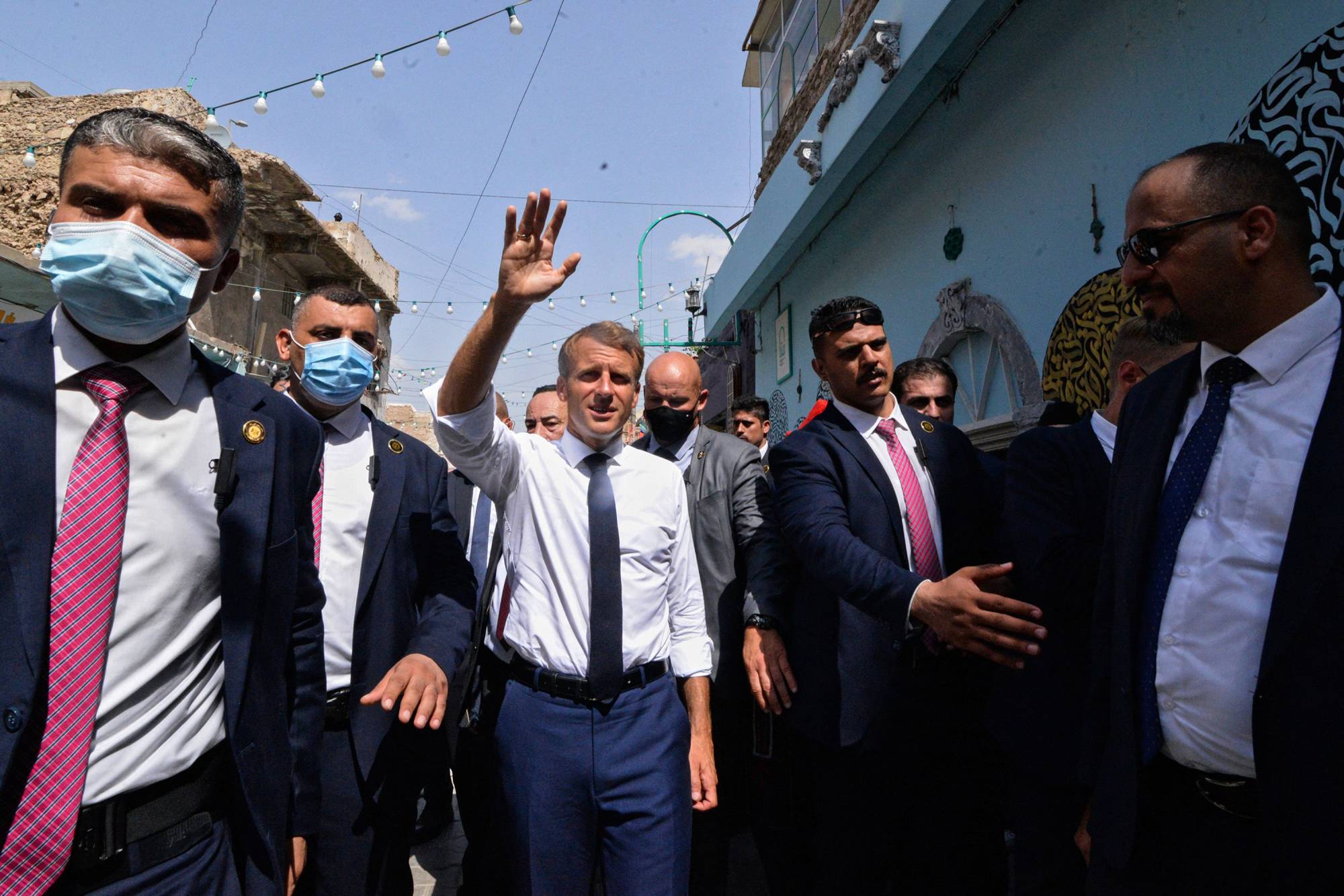 French President Emmanual Macron greets people in Mosul, Iraq, on Sunday. The French leader said a day earlier that France was holding discussions with the Taliban about the humanitarian situation in Afghanistan and the possible evacuation of more people. |  AFP-JIJI