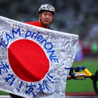 Japan\'s Tomoki Sato celebrates after winning another gold medal at Paralympic Games in Tokyo on Sunday. | REUTERS 