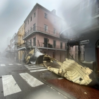 A section of a building\'s roof is blown off during rain and winds in the French Quarter of New Orleans, Louisiana, on Sunday.  | AFP-JIJI