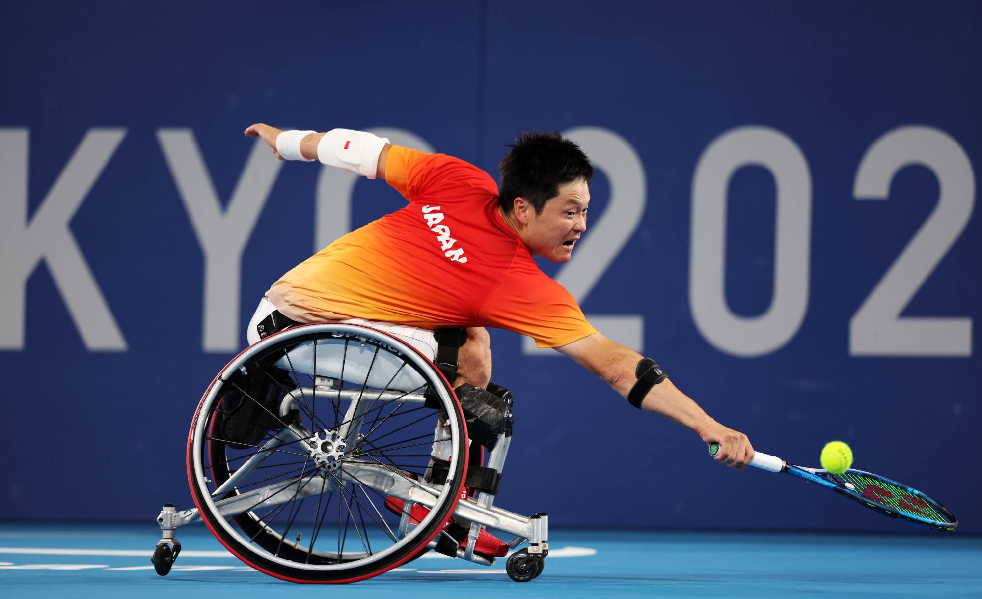 Japan's Shingo Kunieda makes a return to China's Zhenxu Ji during the third round of the men's singles wheelchair tennis. | REUTERS