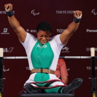 Nigeria\'s Folashade Oluwafemiayo reacts after a clean lift in the women\'s under-86 kg powerlifting final. | REUTERS
