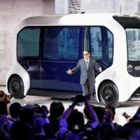 Toyota Motor Corp. President Akio Toyoda shows the e-Palette autonomous concept vehicle at the Tokyo Motor Show in October 2019. | REUTERS