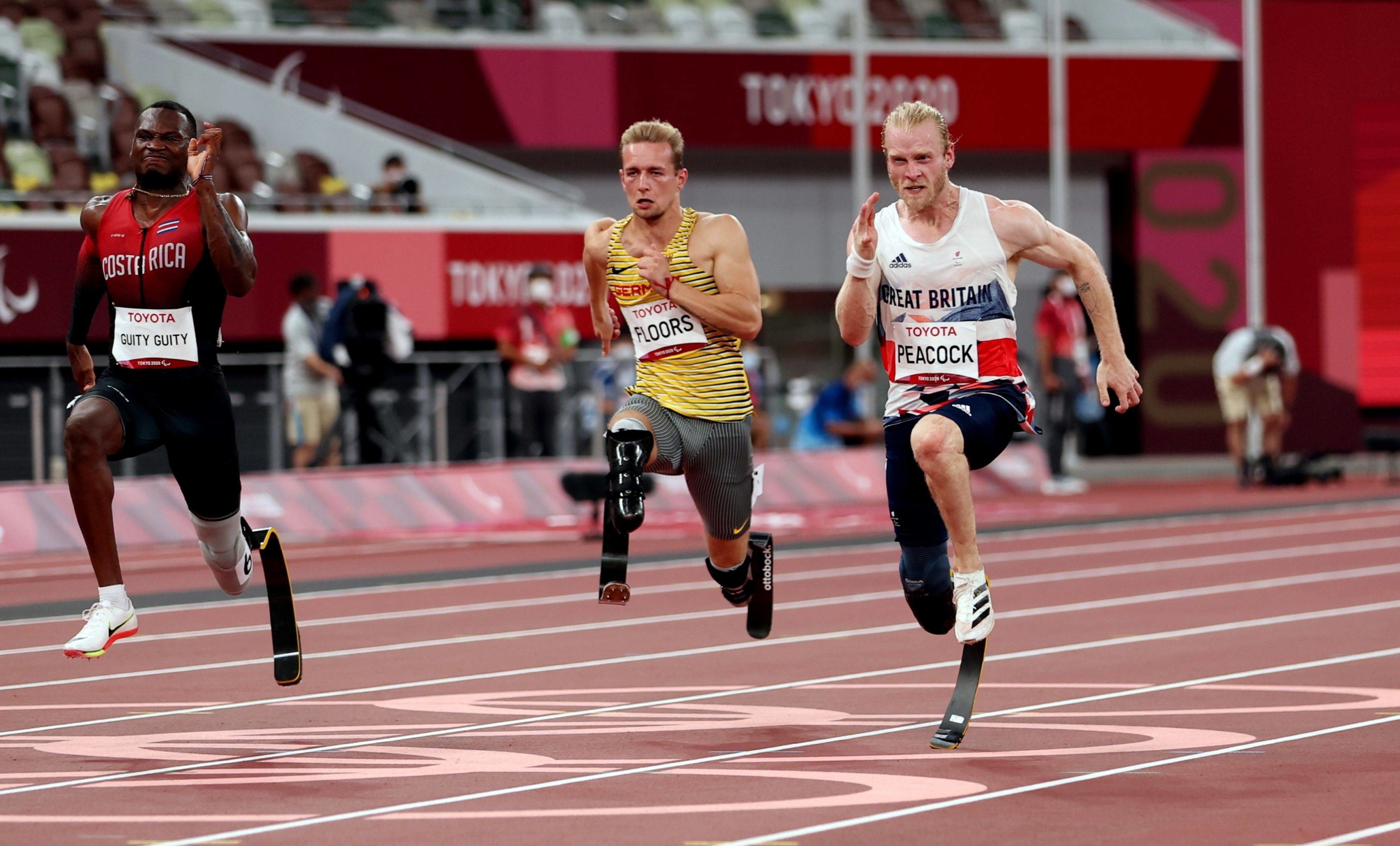 Sherman Isidro Guity Guity of Costa Rica, Johannes Floors of Germany and Jonnie Peacock of Britain compete in the men's T64 100-meter final. | REUTERS