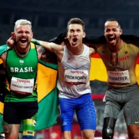 Silver medalist Vinicius Goncalves Rodrigues of Brazil, gold medalist Anton Prokhorov of the Russian Paralympic Committee and bronze medalist Leon Schaefer of Germany celebrate after competing in the men\'s T63 100 meters. | REUTERS