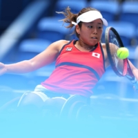 Yui Kamiji of Japan in action against Zhu Zhenzhen of China in the quarterfinal of the women\'s wheelchair tennis competition at the 2020 Tokyo Paralympics on Tuesday. | REUTERS