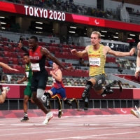 Just 0.03 seconds separated gold medalist Felix Streng of Germany, silver medalist Sherman Isidro Guity Guity of Costa Rica, bronze medalist Johannes Floors of Germany and bronze medalist Jonnie Peacock of Britain at the finish line of the men\'s T64 100-meter final at the 2020 Tokyo Paralympics on Monday. | REUTERS