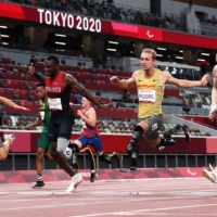 Just 0.03 seconds separated gold medalist Felix Streng of Germany, silver medalist Sherman Isidro Guity Guity of Costa Rica, bronze medalist Johannes Floors of Germany and bronze medalist Jonnie Peacock of Britain at the finish line of the men\'s T64 100-meter final at the 2020 Tokyo Paralympics on Monday. | REUTERS