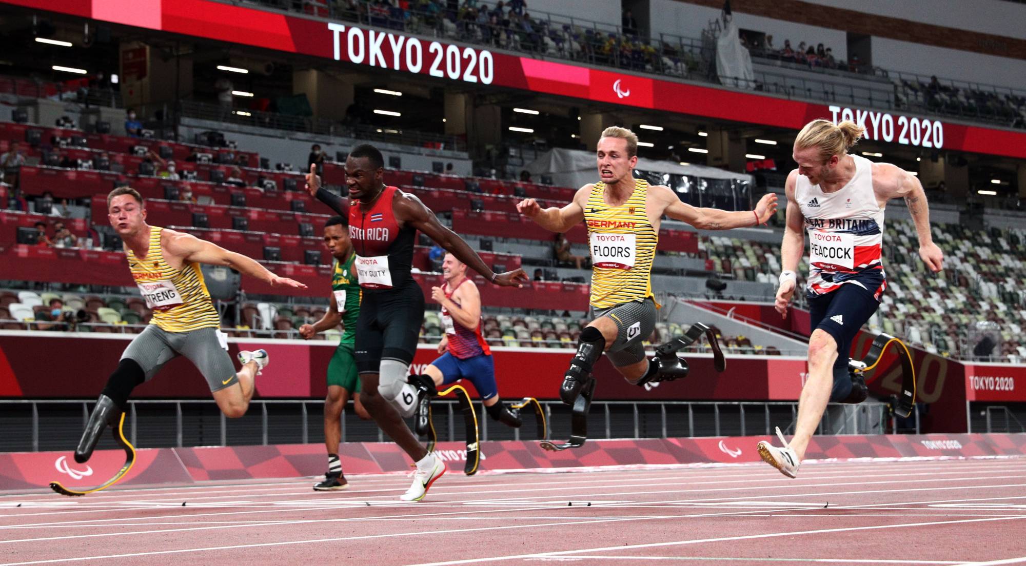 Just 0.03 seconds separated gold medalist Felix Streng of Germany, silver medalist Sherman Isidro Guity Guity of Costa Rica, bronze medalist Johannes Floors of Germany and bronze medalist Jonnie Peacock of Britain at the finish line of the men's T64 100-meter final at the 2020 Tokyo Paralympics on Monday. | REUTERS