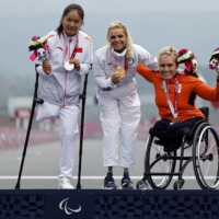 Silver medalist Bianbian Sun of China, gold medalist Oksana Masters of the United States and bronze medalist Jennette Jansen of the Netherlands celebrate during the medal ceremony of the women\'s H4-5 cycling road time trial | REUTERS