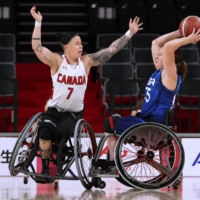 Canada\'s Cindy Ouellet attempts to block USA\'s Courtney Ryan during the quarterfinal of women\'s wheelchair basketball | REUTERS