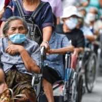 People line up to get vaccinated for COVID-19 at the Central Vaccination Center in Bangkok in July.  | REUTERS