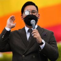 Tanat \"Nat\" Thanakitamnuay speaks during a protest near the Democracy Monument in Bangkok on Aug. 28. | REUTERS 