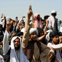 Taliban supporters gather to celebrate the withdrawal of all U.S. troops out of Afghanistan in the city of Kandahar on Wednesday. | AFP-JIJI