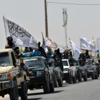 Taliban fighters celebrate the withdrawal of all U.S. troops out of Afghanistan in the city of Kandahar on Wednesday. | AFP-JIJI