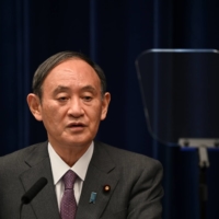 Prime Minister Yoshihide Suga speaks during a news conference in Tokyo on Aug. 25. | POOL /VIA REUTERS