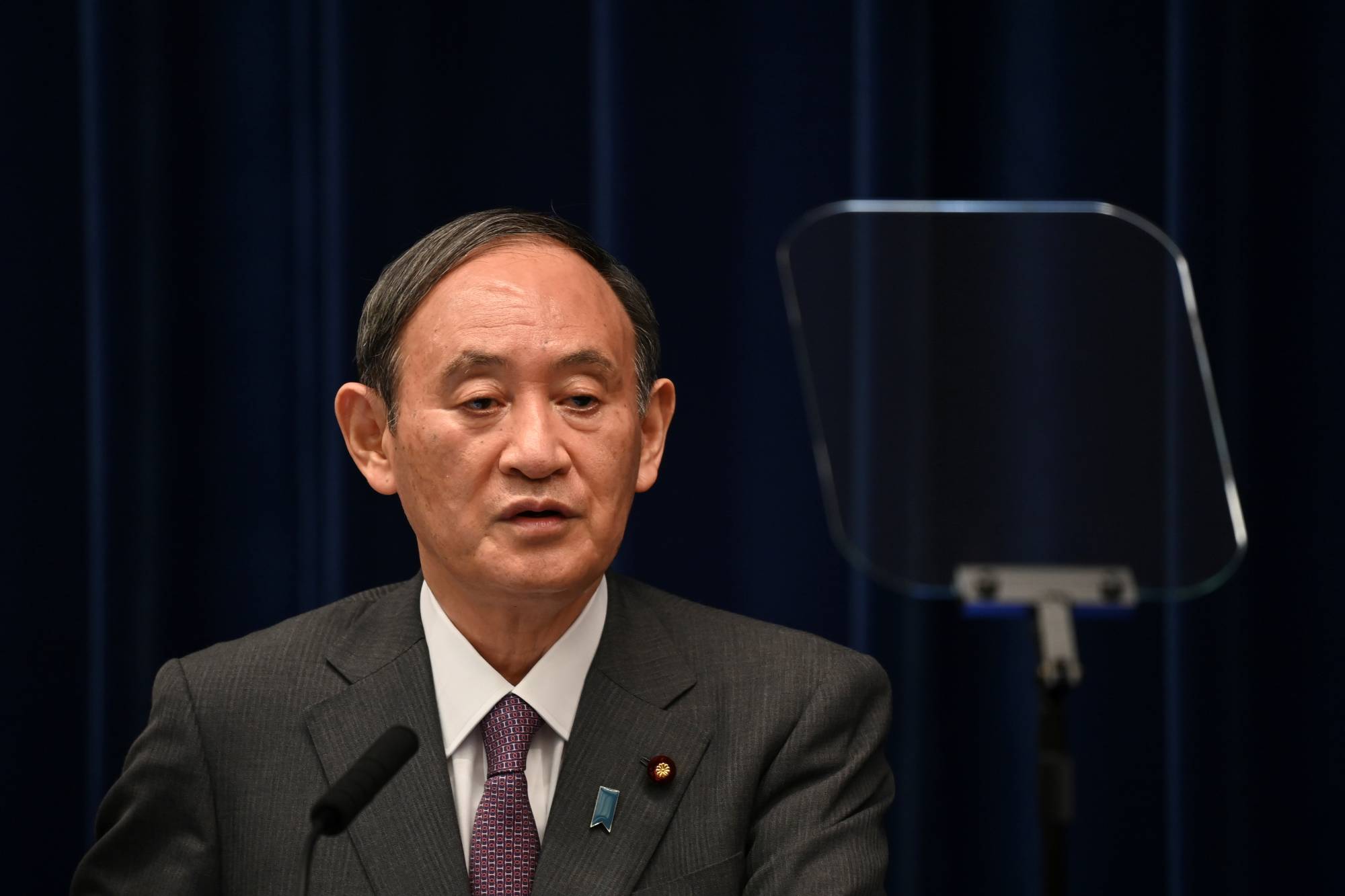 Prime Minister Yoshihide Suga speaks during a news conference in Tokyo on Aug. 25. | Pool /via REUTERS