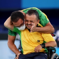 Brazil\'s Maciel Santos celebrates with his coach after winning bronze in the men\'s individual competition | REUTERS