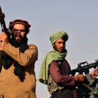 Taliban fighters in the city of Kandahar on Wednesday celebrate the withdrawal of U.S. forces from Afghanistan.  | AFP-JIJI