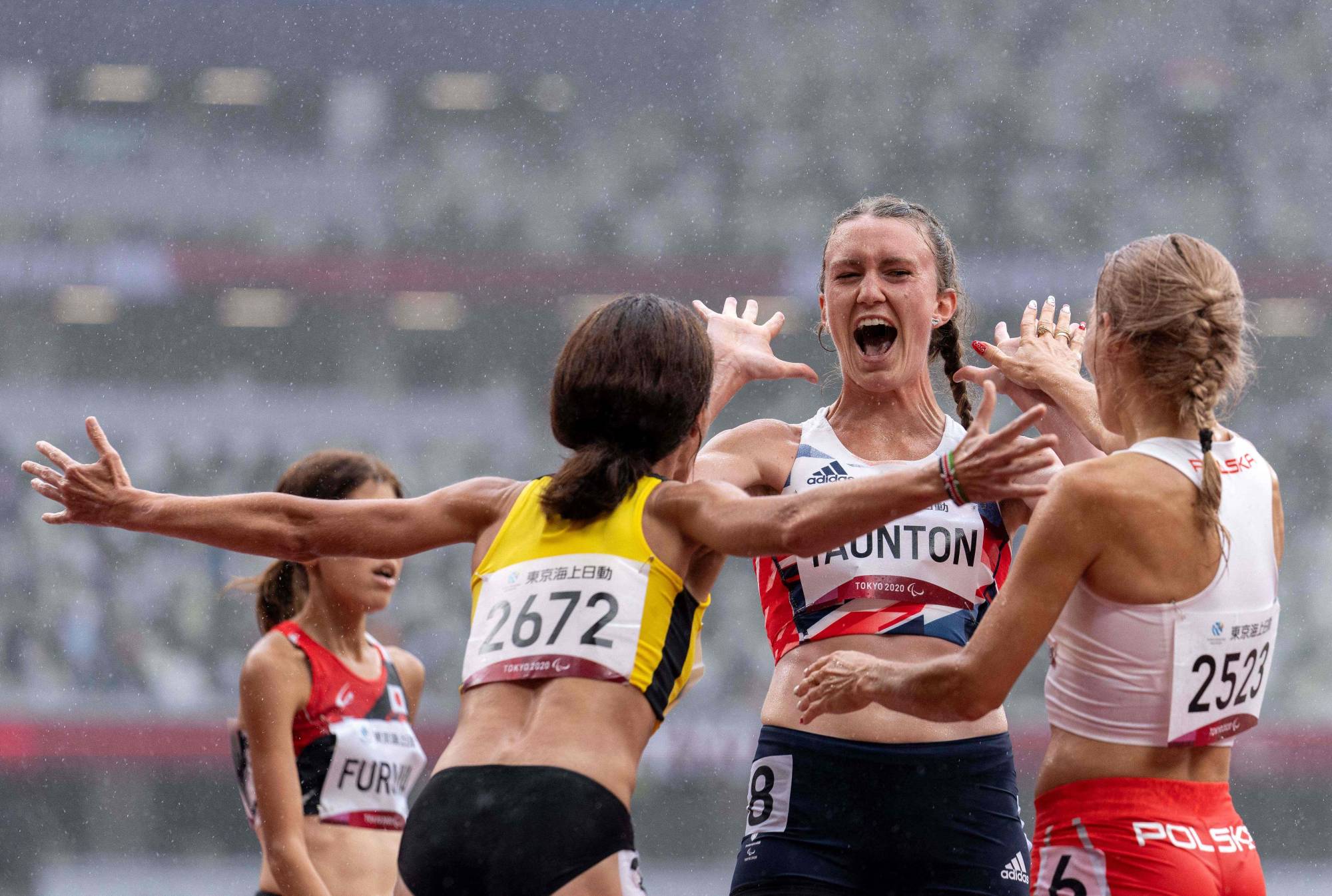 Bronze medalist Hannah Taunton of Britain (center), silver medalist Liudmyla Danylina of Ukraine (left) and gold medalist Barbara Bieganowska-Zajac of Poland celebrating following the women’s T20 1,500 meters. | OIS