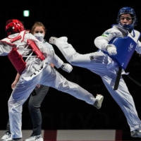 Uzbekistan\'s Ziyodakhon Isakova (right) and Thailand\'s Khwansuda Phuangkitcha compete during the bronze medal match of women\'s K44 under-49-kg taekwondo. | AFP-JIJI