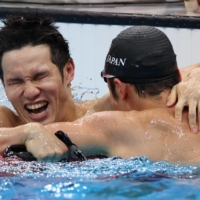 Keiichi Kimura celebrates with teammate Uchu Tomita following the S11 men\'s 100-meter butterfly final. | REUTERS