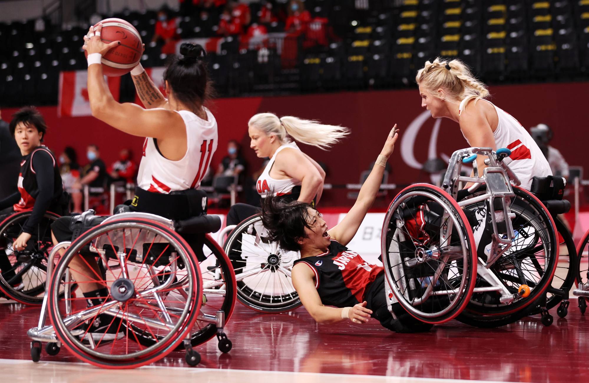 Chihiro Kitada takes a tumble during the Canada vs Japan women's playoff of wheelchair basketball. | REUTERS