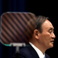 Prime Minister Yoshihide Suga speaks during a news conference in Tokyo in May. | POOL / VIA AFP-JIJI