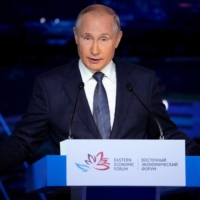 Russian President Vladimir Putin delivers a speech at the Eastern Economic Forum in Vladivostok, Russia, on Friday. | POOL / VIA REUTERS