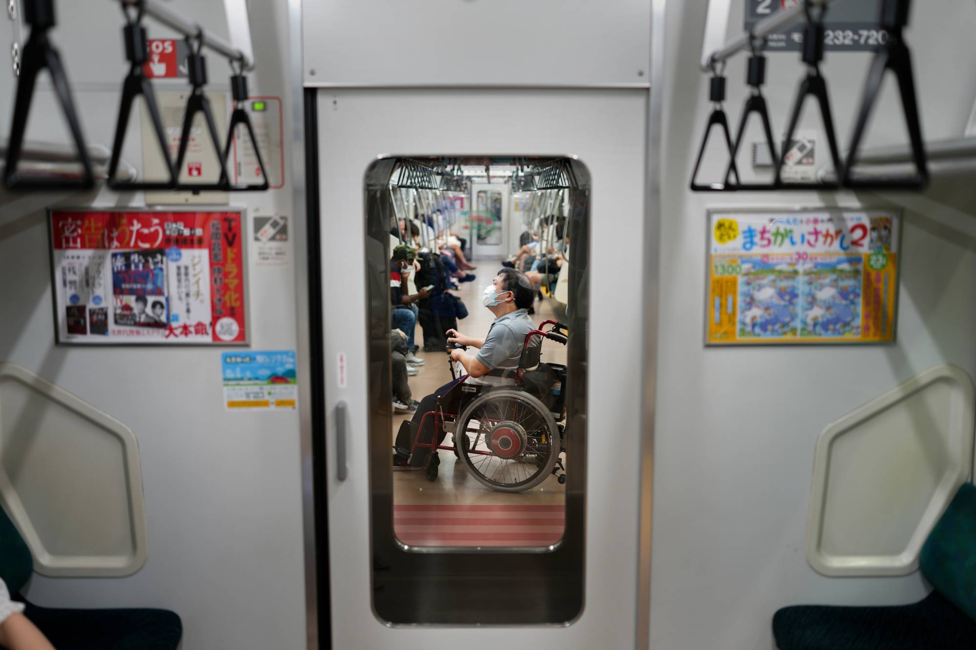 Yuto Hirano, a volunteer for the Paralympics, on the subway in Tokyo on Aug. 23. Hirano said he wished that the Paralympics could have had international spectators, who could have assessed Tokyo’s accessibility measures. | Chang W. Lee/The New York Times