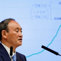 Prime Minister Yoshihide Suga attends a news conference on Japan\'s response to the coronavirus pandemic, at his official residence in Tokyo on June 17. | POOL / VIA REUTERS