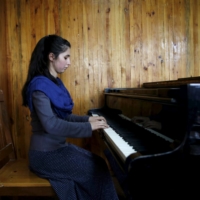 A member of the Zohra orchestra, an ensemble of 35 women, practises during a session at Afghanistan\'s National Institute of Music in Kabul in 2016.  | REUTERS