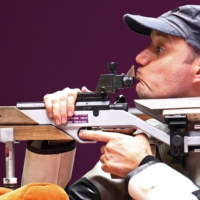 Dragan Ristic of Serbia in action during the mixed 50-meter rifle prone SH2 final | REUTERS