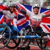 Britain\'s Hannah Cockroft and Kare Adenegan celebrate after winning gold and silver in the women\'s T34 800 meters. | REUTERS