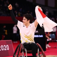 Daiki Kajiwara celebrates after winning his badminton men\'s singles WH2 gold-medal match against South Korea\'s Kim Jung-jun on Sunday at Yoyogi National Stadium. | REUTERS