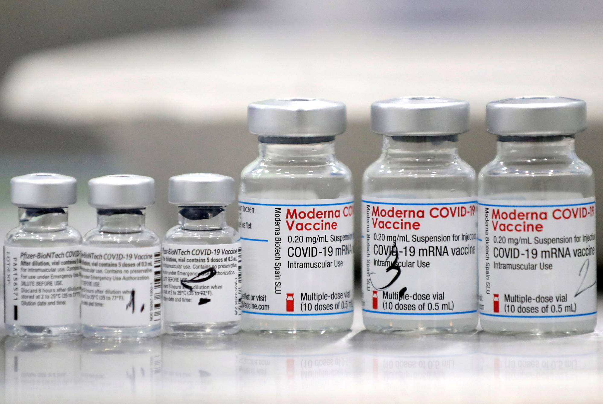 Vials of COVID-19 vaccines developed by Pfizer-BioNTech and Moderna | REUTERS