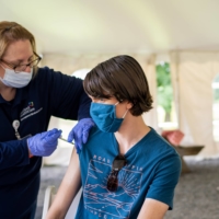 A teenager receives a COVID-19 vaccine at a pop-up clinic in Middlefield, Connecticut.  | CHRISTOPHER CAPOZZIELLO / THE NEW YORK TIMES
