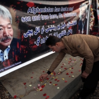 A man lights candles for Japanese doctor Tetsu Nakamura in Kabul days after he was killed in an attack Jalalabad in December 2019. | REUTERS 