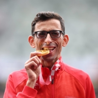 Morocco\'s gold medalist of men\'s T12 marathon El Amin Chentouf celebrates on the podium in the medal ceremony. | REUTERS