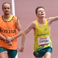 Australia\'s Jaryd Clifford (right) and his guide cross the finish line to win the men\'s T12 marathon. | AFP-JIJI