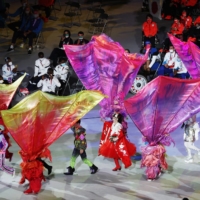 Customed performers parade during the closing ceremony. | REUTERS