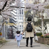Mothers raising children are feeling particularly stressed amid the COVID-19 pandemic, a survey finds. | KYODO