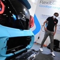 The battery exchange and charging system for an XEV Yoyo 3D-printed electric car is presented during a media preview at the International Motor Show in Munich on Monday. | AFP-JIJI