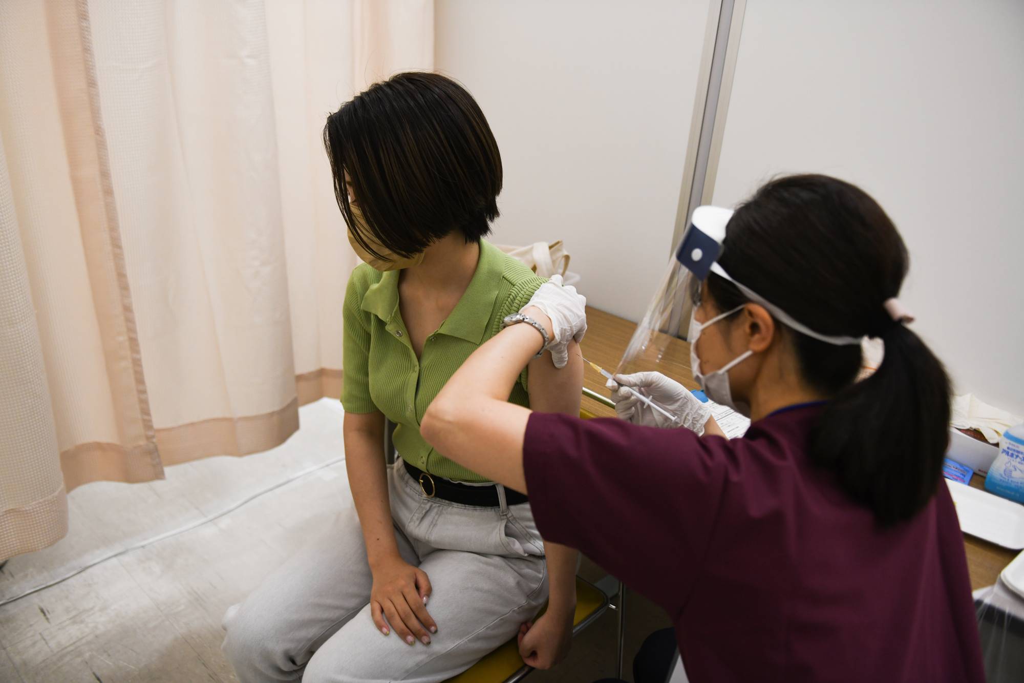 A health care worker administers a dose of the Moderna Inc. Covid-19 vaccine in the city of Saitama last month. | BLOOMBERG
