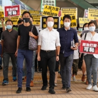 Former pro-democracy lawmakers Ted Hui Chi-fung, Raymond Chan Chi-chuen and Eddie Chu Hoi-dick appear outside Hong Kong\'s West Kowloon Magistrates\' Courts.  | REUTERS