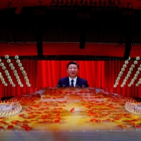 A screen shows Chinese President Xi Jinping during a ceremony marking the 100th anniversary of the founding of the Communist Party of China, on June 28. | REUTERS