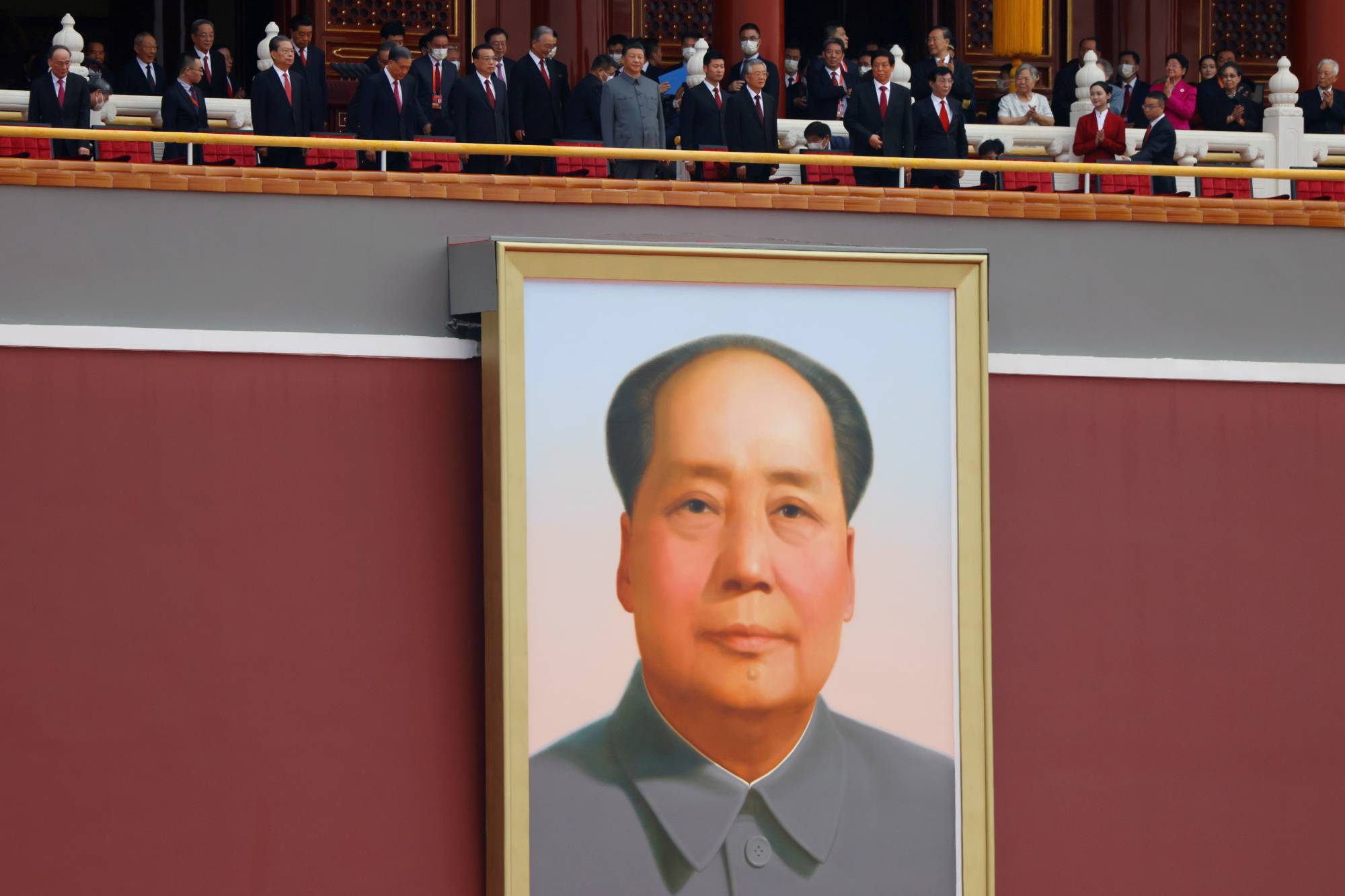 Chinese President Xi Jinping and other leaders stand above a giant portrait of late Chinese Chairman Mao Zedong on July 1. | Reuters