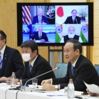 Prime Minister Yoshihide Suga addresses a \"Quad\" meeting with leaders of the United States, Australia and India held online in March. | KYODO
